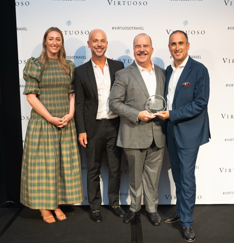 Anthony and David Goldman accept awards from Matthew D. Upchurch at the Virtuoso Regional Forum awards.